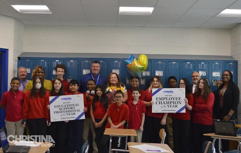 Photo of Donna Smith with students and administration. Employee Champion and Educational Support Professional of the Year.